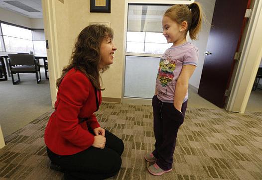 Pediatric neurologist Catherine Mazzola talks with one of her patients, Kayley Lancaster, whose parents have private insurance. The doctor does see Medicaid patients, but complained it took her staff nine months to complete the paperwork to get her on their rolls. (Robert Sciarrino)