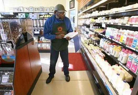Dennis Terry takes inventory at the Mandela Food Cooperative on Seventh Street in west Oakland, Calif., on Wednesday.