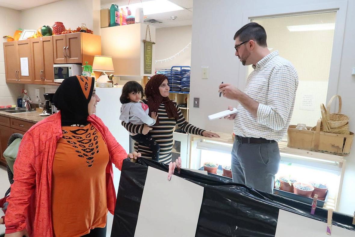 Reporter Justin Murphy speaking with parents at the EarlyOn child and family center in Windsor, Ontario for the Time To Educate 