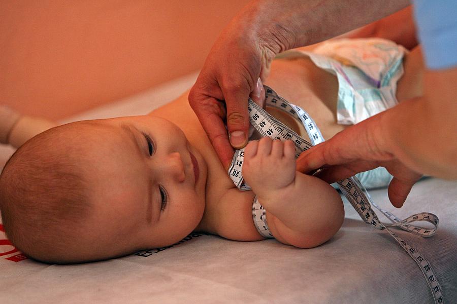 An infant gets measured as part of a health check