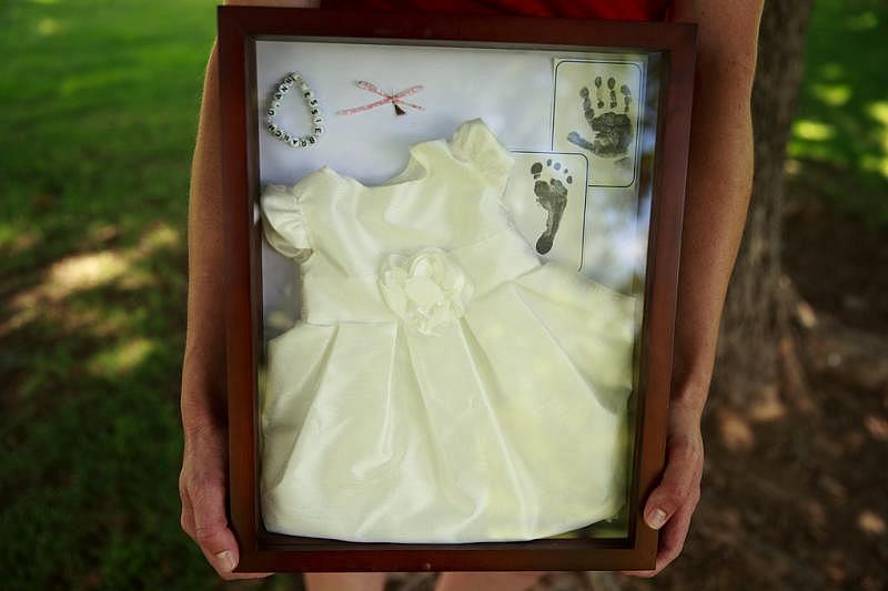 The Branch family keeps mementos — a bracelet, a dress, a snip of hair — from their daughter Gianna’s short life. Steve Branch said he wishes the cluster were a “higher priority” for the state. (Erika Schultz / The Seattle Times)