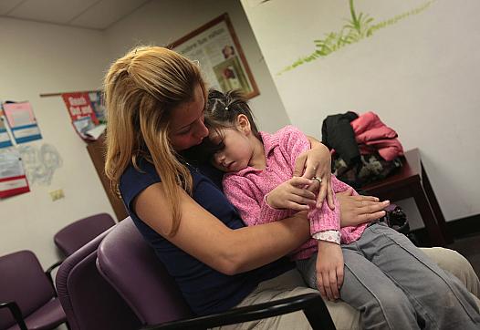 Woman comforting her child at hospital 