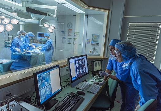 Doctors performing treatment in an operation theatre with healthcare technology