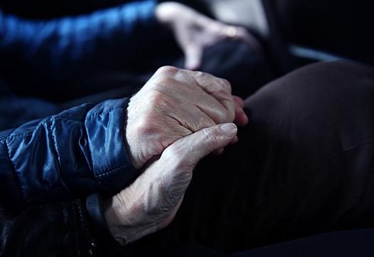 elders holding hands