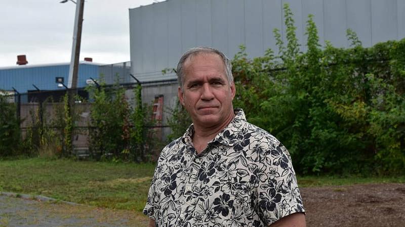 Chris Marchi stands where the homes of Neptune Road once stood at the entrance to Wood Island Park