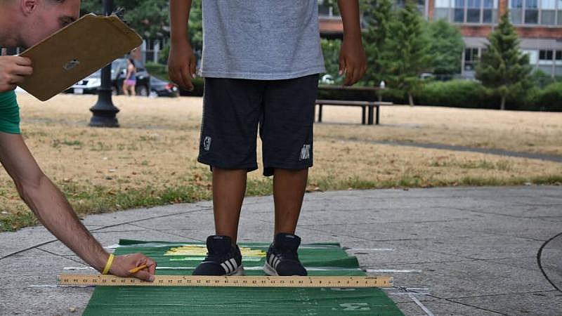 Let's Go Movin' coordinators test the physical fitness of program participants at East Boston's Memorial Park. 