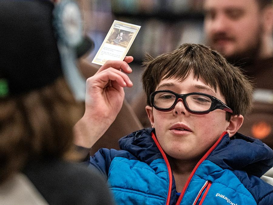 Harrison showing his Pokemon card to a gathering