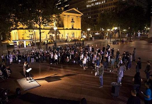 Members of recovery programs, graduates and supporters listen as Patty Katz discusses her battle during an event celebrating recovery in Pioneer Courthouse Square in Portland, Ore. Alton Strupp/the Courier-Journal