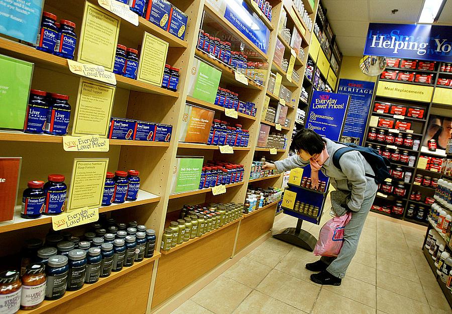 A shopper browses supplements at a GNC vitamin store in New York City.