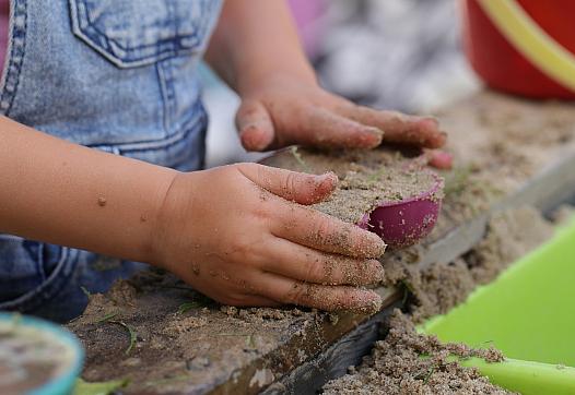 Child playing with sand.