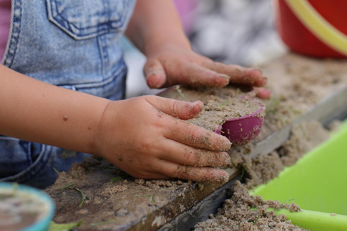 Child playing with sand.