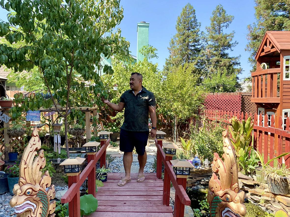 Danny Kim walking in his backyard garden on Sept. 15 in Fresno, Calif.