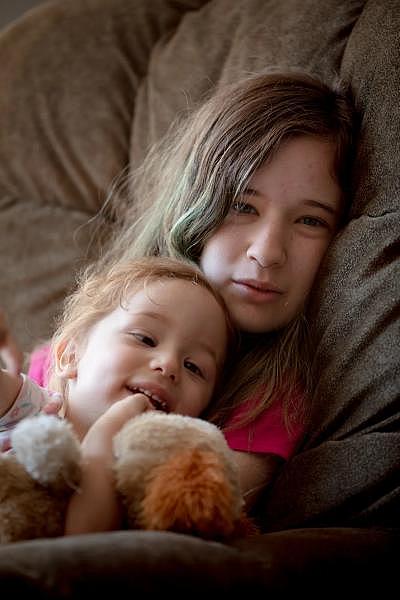 Loryann Pisani, 16, holds her sister, Bethany Cortes, 2, while adults move their belongings to move to a new place in West Hartford. “Kind of nervous,” Loryann said. “It’s new everything.” YEHYUN KIM / CTMIRROR.ORG