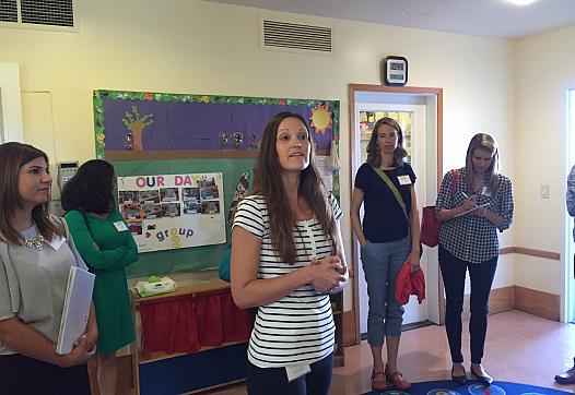 Nicole Fauscette, supervisor of an intensive day treatment program for preschool-aged kids at the Children’s Institute, guides National Health Journalism Fellows on a tour of the center’s Torrance campus.