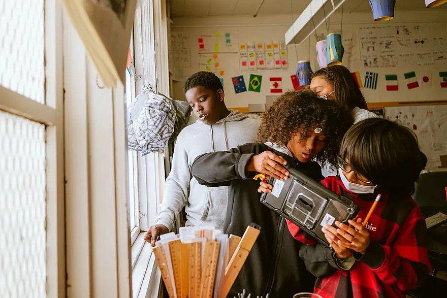 Children in classroom near window.