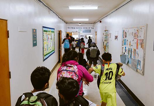 Children walking in the school aisle