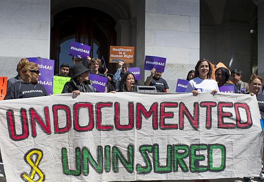 Advocates for a bill to provide health care to undocumented immigrants rally in at the Capitol in Sacramento. (Photo by LA Times/Hector Amezcua)