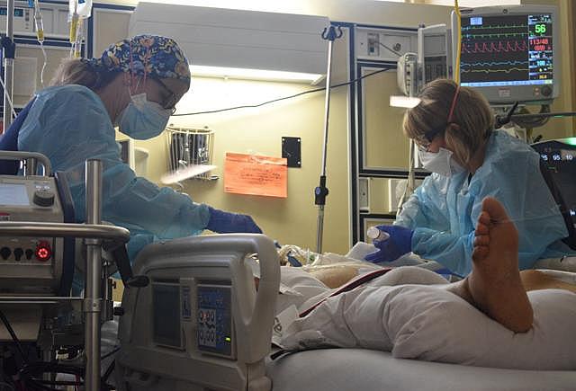 Registered nurses Karen Miner, left, and Dana List check on a COVID-19 patient in Marian Regional Medical Center's critical care unit on Sept. 9.  Randy De La Peña, Contributor