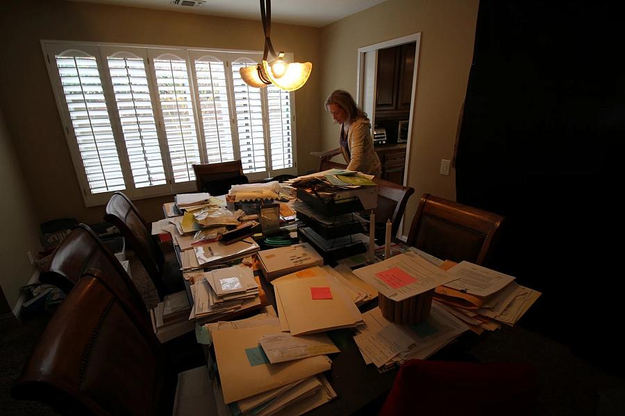 A person looking over documents on their desk.