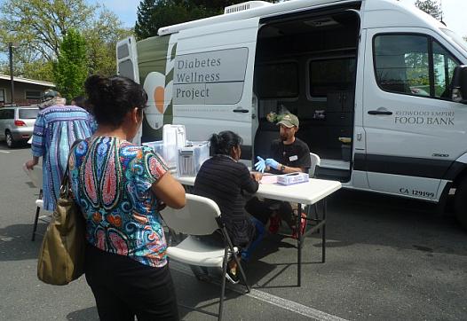 Morgan Smith, a registered nurse with the Redwood Empire Food Bank Diabetes Wellness Project, conducts free diabetes screenings once a month at the Graton Day Labor Center. The center serves as a conduit between its members — many of whom are undocumented — and health organizations around the region. (Lisa Morehouse/KQED)