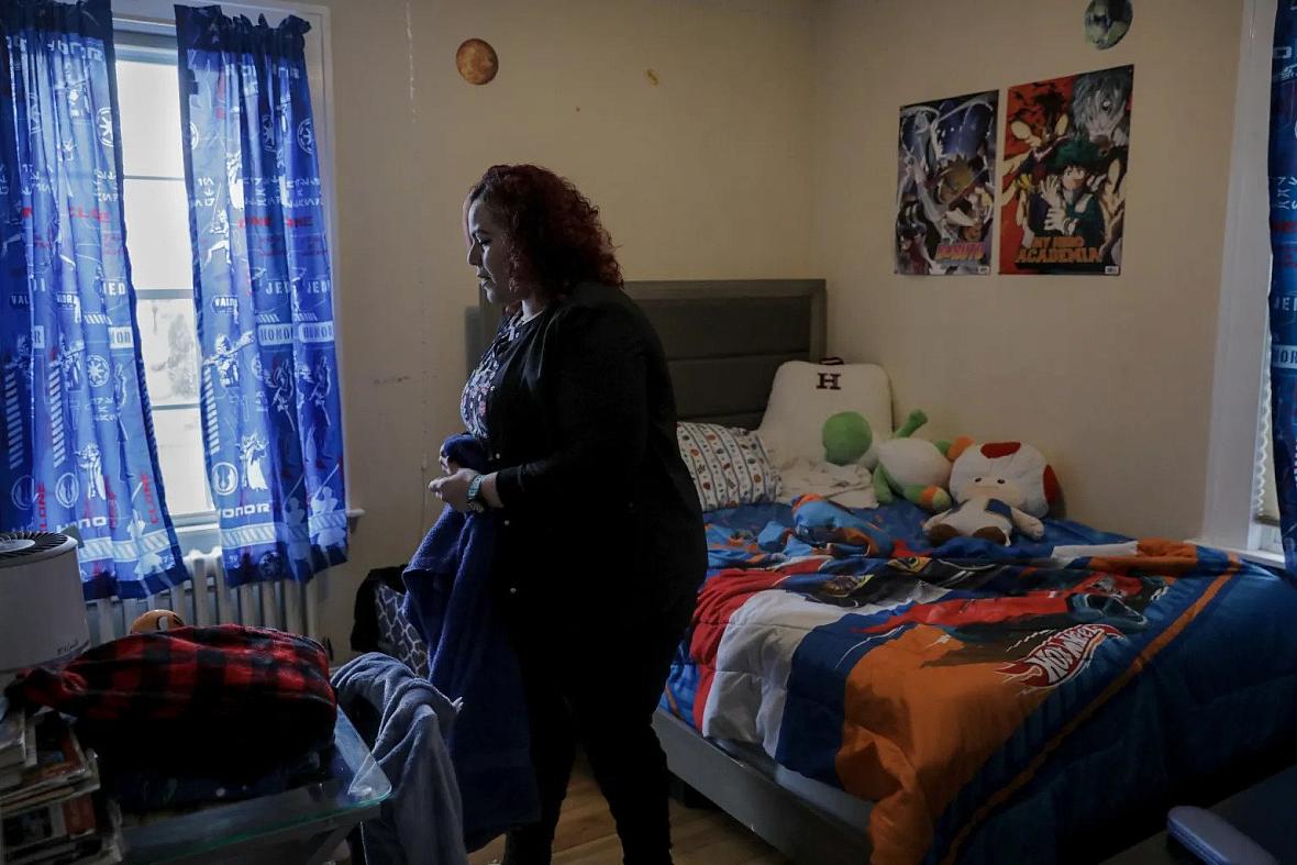 Carmen Diaz cleans her 9-year-old son’s room in Hamden. YEHYUN KIM / CT MIRROR