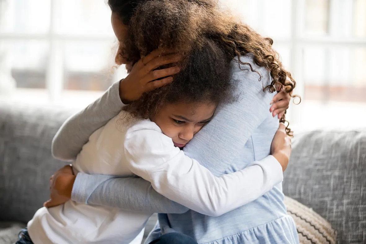 Image of a girl hugging a woman