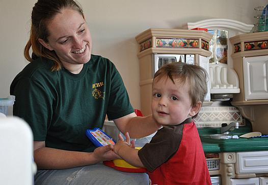 Health caregiver with toddler