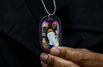 Lorrie Johnson wears a necklace with a picture of her late granddaughter Dajha Richards.