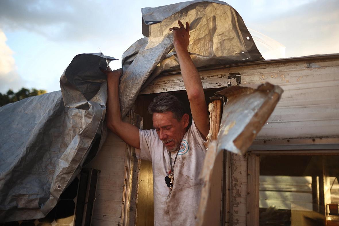 Robert Hernandez exits his trailer at an encampment on the baseball fields near Columbus Park in San Jose on Monday Monday, Sept