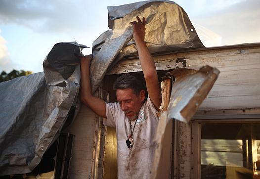 Robert Hernandez exits his trailer at an encampment on the baseball fields near Columbus Park in San Jose on Monday Monday, Sept