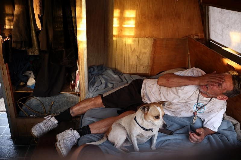 Hernandez rubs his eyes while laying in his trailer at the encampment on the baseball fields near Columbus Park in San Jose on Monday, Sept. 19, 2022. (Shae Hammond/Bay Area News Group)