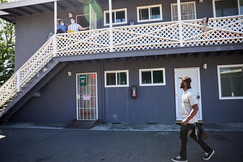 Henderson looks up in excitement at HomeFirst employees as he's shown his new apartment in San Jose on Thursday, July 22, 2022. (Shae Hammond/Bay Area News Group)