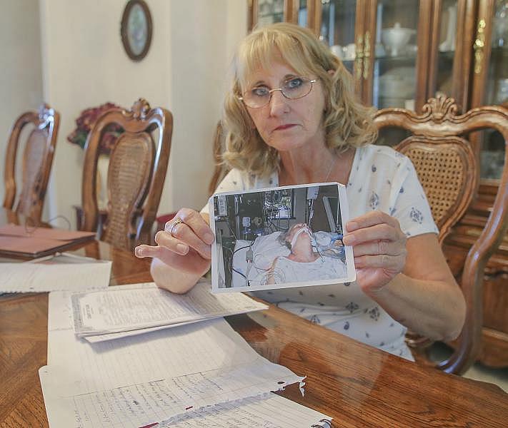 Elizabeth Mulikin holds a photograph of her sister, Edie Preller, at Kaweah Delta Medical Center in Visalia as she battled valley fever. Preller first became ill in October of 2005 but was misdiagnosed until two-years later. She passed away on May 18th 2008. Credit: Henry A. Barrios/The Californian