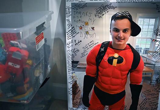 An image of Zachary Chafos, dressed as Mr. Incredible, at his Maryland home