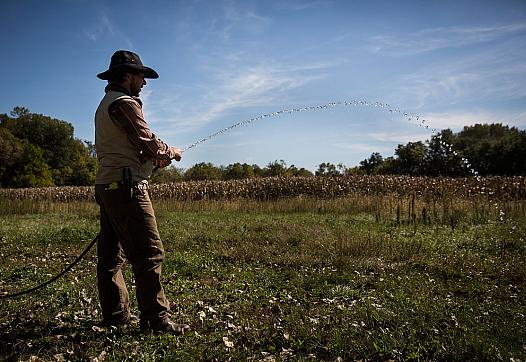 Man watering his farm.