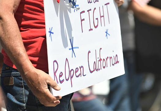 Nearly 300 people rallied at the corner of Mooney Boulevard and Caldwell Avenue urging Gov. Gavin Newsom to reopen the state.